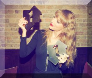 Taylor Swift celebrates her Official Charts Double with Number 1 Awards for Midnights (L) and Anti-Hero (R) (Credit: OfficialCharts.com)