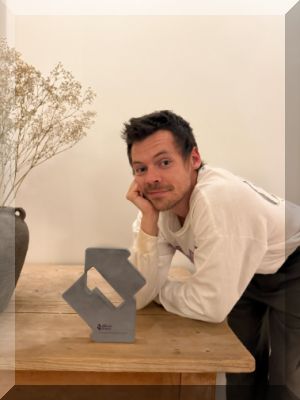 Harry Styles poses with his Official Number 1 Award for Aperture (credit: Official Charts) 